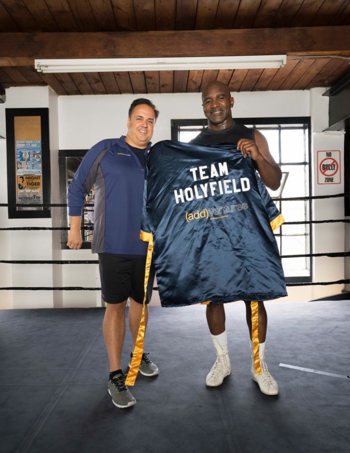(ADD)VENTURES PRESIDENT AND CEO Steve Rosa stands with boxing great Evander Holyfield. Providence-based communications firm (add)ventures received two Emmys for a public service announcement it directed, filmed and edited for the Prostate Cancer Foundation last year featuring Holyfield. / COURTESY (ADD)VENTURES