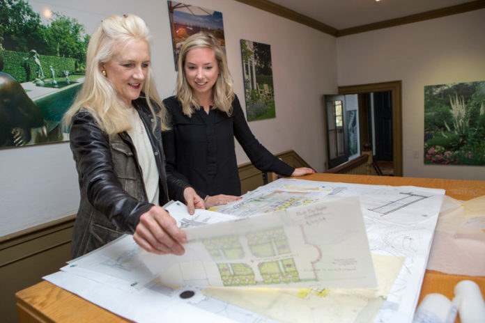 NATURAL FOCUS: Katherine Field, left, and landscape architect Lisa Frazier review plans at the Newport firm. Field works with stone and other natural materials for her designs. / PBN PHOTO/KATE WHITNEY LUCEY