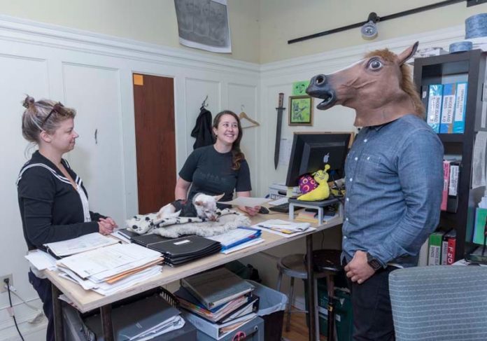 NEIGH TO NEW RULE: AS220 Managing Director Shauna Duffy, center, said the deadline set by a new rule regarding overtime for salaried employees is unrealistic. Also pictured are Sarah Quenon, general manager, and Guillermo Lopez, IT director, in costume, at the nonprofit. / PBN PHOTO/ MICHAEL SALERNO