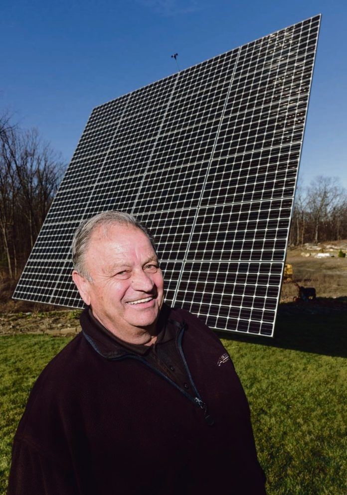 DISRUPTED BY DISTRIBUTION: As more renewable energy projects are built by businesses and homeowners, such as this solar array at Arnold Abatecola's Johnston home, the financial structure of the electricity delivery system is being undermined. / PBN FILE PHOTO/MICHAEL SALERNO