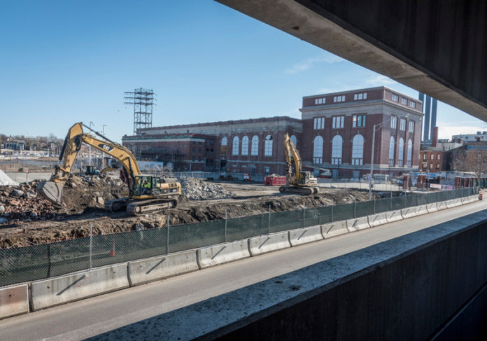 REBUILDING A CITY: By the beginning of 2016, construction on the multifaceted, $220 million South Street Landing project was underway, with the foundation being dug for a new parking garage, foreground, while the interior work on the old power station had begun. / PBN FILE PHOTO/MICHAEL SALERNO