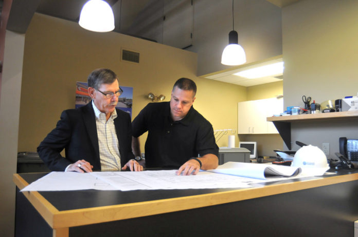 PLANNING FOR GROWTH: In 2013 and 2014 New England Construction was the fastest-growing company in the region with revenue of $25 million to $75 million. In 2013 company founder and CEO David A. Sluter talks with then-President John D. Pignataro. / PBN FILE PHOTO/FRANK MULLIN