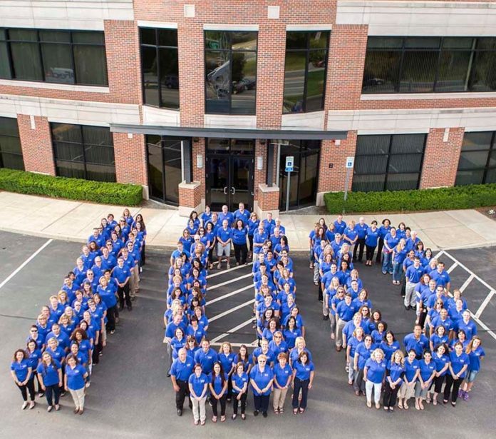 A CENTURY OF DEDICATION: Navigant employees mark the credit union's 100th anniversary in 2015 at their Smithfield headquarters. A focus on family and community has been part of the company's approach since it was founded in the basement of a neighborhood parish in Central Falls in 1915. / COURTESY NAVIGANT CREDIT UNION