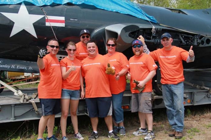 SHIPSHAPE: Embrace Home Loans has a culture of supporting employee community involvement, including volunteering efforts like this one at the USS Saratoga Museum in North Kingstown. / COURTESY EMBRACE HOME LOANS