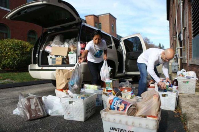 GLOBALLY FOCUSED, LOCALLY ENGAGED: Collette employees sort items donated during the company's annual Thanksgiving food drive. / COURTESY COLLETTE