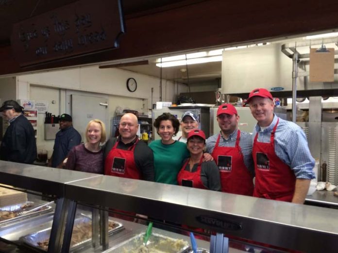 READY TO SERVE: Members of Shawmut's Providence office join Gov. Gina M. Raimondo in serving meals at Amos House last Thanksgiving. / COURTESY SHAWMUT DESIGN AND CONSTRUCTION