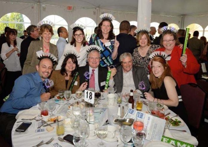 BACK IN THE WINNERS' CIRCLE: Partridge Snow & Hahn employees celebrate at the 2015 Best Places To Work event. / COURTESY PARTRIDGE SNOW & HAHN