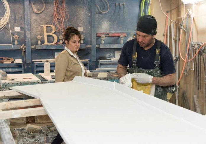 COUNTER CULTURE: Tracey Beck, general manager of KB Surfaces, is seen in the shop with Jose Vasquez, solid-surface fabricator. The Johnston-based manufacturer creates custom cuts of engineered or natural-stone countertops. / PBN PHOTO/MICHAEL SALERNO