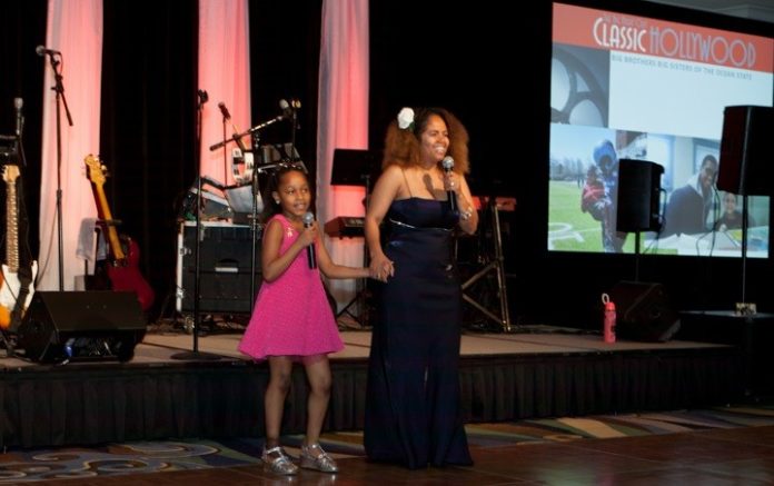 Big Sister of the Year Sandra Catrone and Shanya, her little sister, perform at the Big Brothers Big Sisters annual gala. / COURTESY RUTH CLEGG