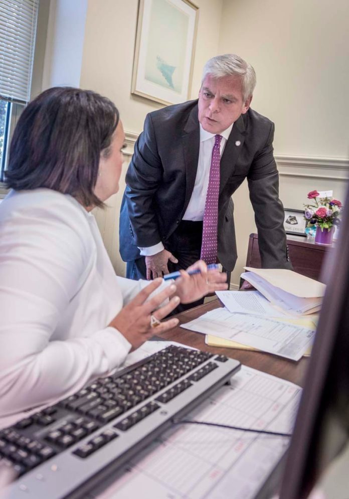 PROACTIVE APPROACH: Warwick Mayor Scott Avedisian speaks with his press secretary, Courtney Marciano, at his office. Avedisian suggested creating a statewide OPEB trust to help small local plans. / PBN PHOTO/MICHAEL SALERNO PROACTIVE APPROACH: Warwick Mayor Scott Avedisian speaks with his press secretary, Courtney Marciano, at his office. Avedisian suggested creating a statewide OPEB trust to help small local plans. / PBN PHOTO/MICHAEL SALERNO