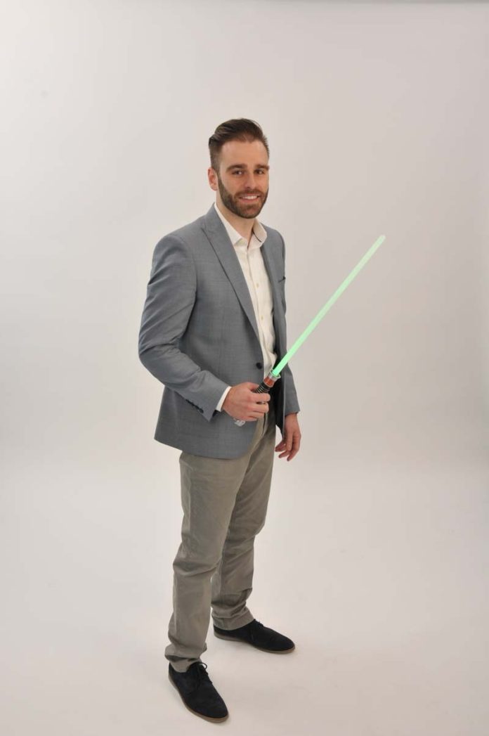 THE PROP: Daniel Xavier demonstrates his passion for "Star Wars" with a  lightsaber, proving that he has found a balance between work and play.