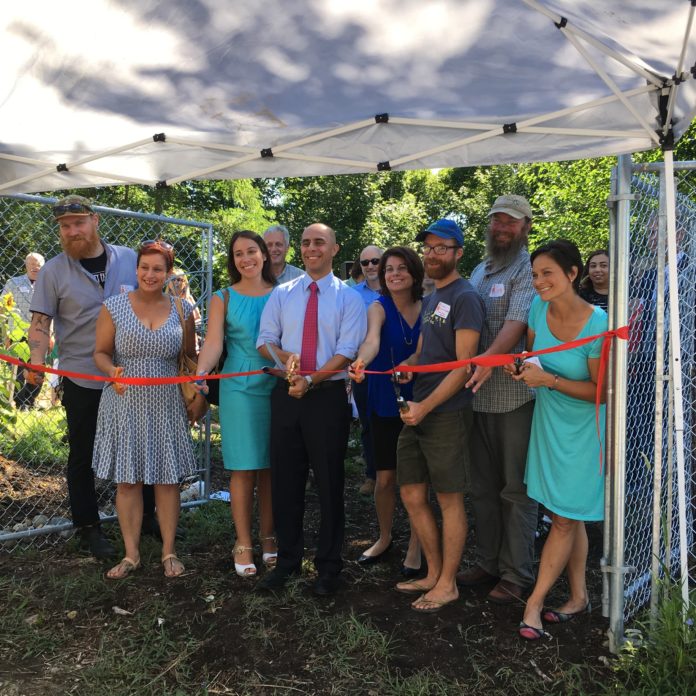 FROM LEFT TO RIGHT, Southside Community Land Trust Community Growers Director Rob Booz; Tina Shepherd of ONE Neighborhood Builders; Diana Perdomo of United Way of Rhode Island; Ken Ayers of R.I. Department of Environmental Managament; Providence Mayor Jorge O. Elorza; Terry Sullivan of the Nature Conservancy, Mia Patriarca of the R.I. Department of Health; Sky Hill Farmer Adam Graffunder; Scott Comings of the Nature Conservancy; and SCLT's Executive Director Margaret DeVos attend the ribbon cutting ceremony Wednesday morning celebrating the newly renovated Sky Hill Farm on Amherst Avenue in Providence. / COURTESY SOUTHSIDE COMMUNITY LAND TRUST