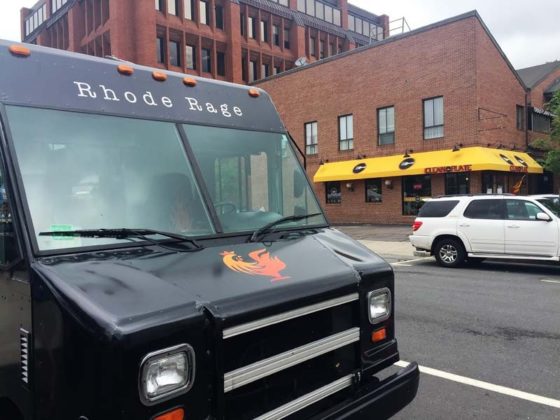 HEALTHY COMPETITION? A food truck operates across the street from Clean Plate Inc. in Providence. Restaurant owner Susan R. Alper doesn't think the food trucks that come to serve a nearby flea market have hurt her business. / PBN PHOTO/ELI SHERMAN