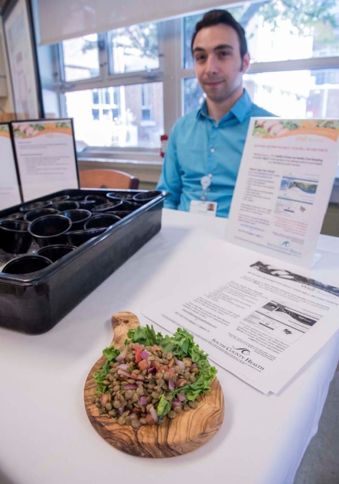 FOOD FOR THOUGHT: Offerings at South County Health's cafeteria are designed to support wellness efforts. This day a food tasting of citrus-spiced lentil salad was offered by Rob Fancher, a diet and nutrition intern from Johnson & Wales University. / PBN PHOTO/MICHAEL SALERNO