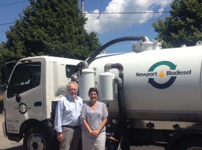 Robert Morton, chairman of the board for Newport Biodiesel, and Jocelyn Nacci, right, of Webster Bank, pose with the company’s new collection truck outside Newport Biodiesel’s facility in Newport. / COURTESY WEBSTER BANK