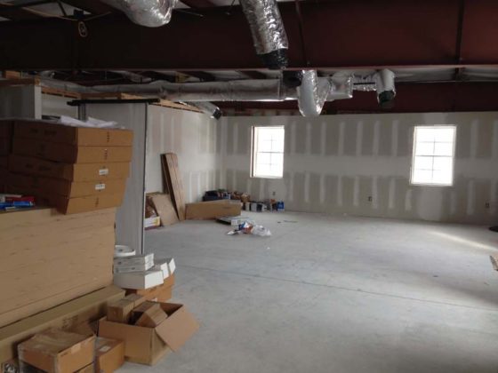 SOMETHING NEW IN STORE: This photo shows how the combined classroom looked before renovations. It was used for storage. Windows facing east in background.
