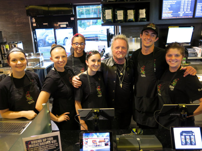 KEEPING THE BEAT: Aerosmith drummer Joey Kramer, third from right, is seen with staff members of his recently opened Rockin' & Roastin' Café in North Attleboro. / COURTESY ROCKIN' & ROASTIN' CAFÉ