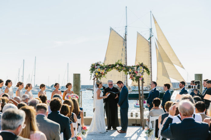 BY THE SEA: The Newport Yachting Center has been rebranded as The Bohlin, a wedding and social-event host for  gathering such as the above wedding near the downtown Newport marina. / COURTESY NEWPORT HARBOR CORP.