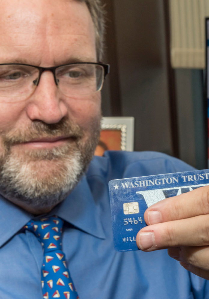 BOOSTING SECURITY: William K. Wray, executive vice president and chief risk officer at The Washington Trust Co., displays the new chip technology on credit and debit cards. / PBN PHOTO/MICHAEL SALERNO