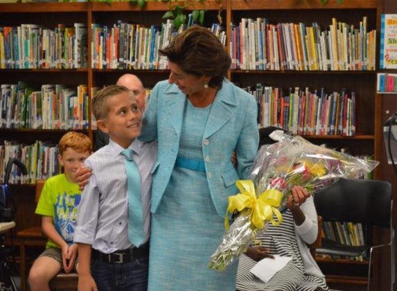 GOV. GINA M. Raimondo receives flowers from Francis J. Varieur School student Dabian Rainville on Wednesday.. Raimondo was at the Pawtucket school to discuss her strategic reading goal for students - she wants three out of four third-graders to score proficient or higher in reading by 2025, the year most children born this year will complete third grade. / COURTESY GOVERNOR'S OFFICE