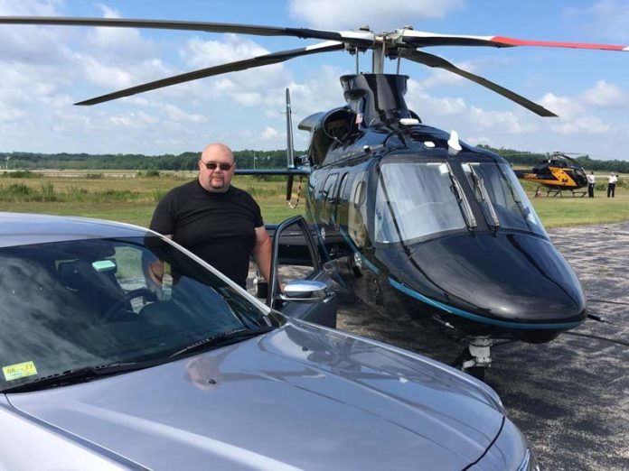 READY TO ROLL: Courtney Sojka, founder of Ballistic Security Enterprises, with some of the transportation options at his disposal: a Bell 222 helicopter and a Chrysler 300c. / COURTESY BALLISTIC SECURITY ENTERPRISES