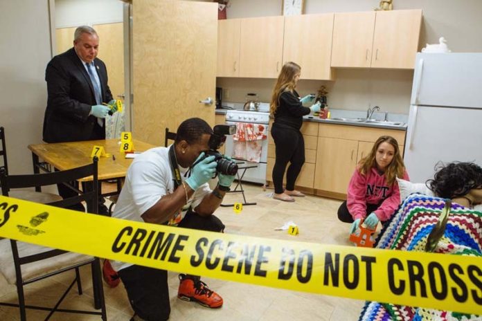 ALL IN THE DETAILS: New England Institute of Technology students, from left, Ray Angell, Shaun Mactavious, Courtney Beauchamp and Mikayla Guarino, learn how to process a crime scene as part of the school's criminal justice degree program. / PBN PHOTO/RUPERT WHITELEY
