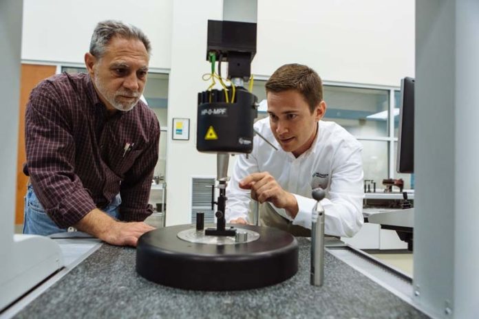 PINPOINT MEASUREMENT: Hexagon Manufacturing Intelligence helps other companies manufacture to more exacting standards, thanks to efforts by engineers like Paul Racine, left, and Scott Carlson. / PBN PHOTO/RUPERT WHITELEY