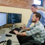 IN THE RIGHT PLACE AT THE RIGHT TIME: Datarista founder and CEO Pat Sabatino, standing, has had no problem finding the right talent in Providence, including Dave Counts, senior front-end engineer for the cloud-based, data-management startup. / PBN PHOTO/RUPERT WHITELEY