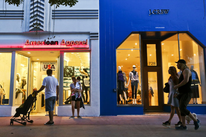 PEDESTRIANS pass in front of American Apparel LLC and J.Crew Group Inc. stores at the Lincoln Road Mall in Miami Beach, Fla. / BLOOMBERG NEWS FILE/SCOTT MCINTYRE