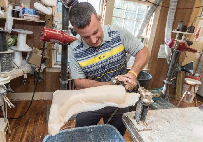 ULTIMATE PRECISION: Joshua R. James, owner of South County Artificial Limb & Brace Co., works on a right-ankle foot orthosis. James admits to being a perfectionist in his trade, which he says requires the utmost precision. / PBN PHOTO/MICHAEL SALERNO