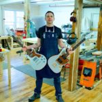 ELECTRIC COMPANY: Bill Paukert, founder of Unified Guitar Works in Warren, displays two of his creations, which are made from sustainable materials. / COURTESY BILL PAUKERT