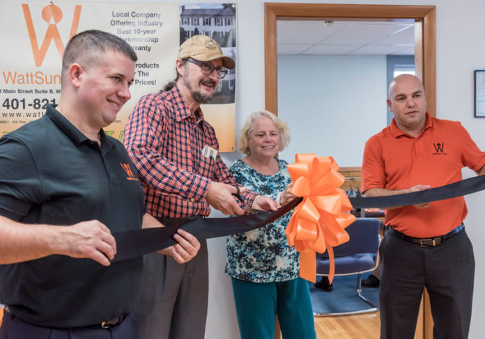 THE HEAT IS ON: From left, Dennis Watson, CEO and co-founder of Wattsun Solar in West Warwick, with Charles and Charlotte Gilbert, the company's first customers at the new office, and Antonio Giorgi, chief financial officer and co-founder. / PBN PHOTO/MICHAEL SALERNO