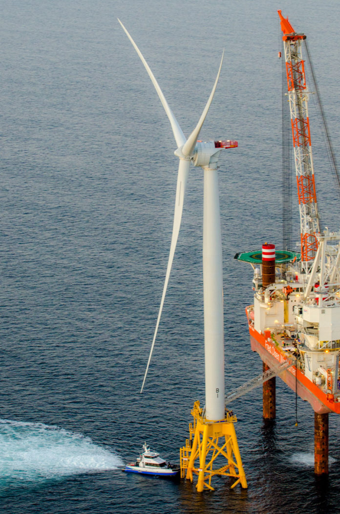 STANDING TALL: Deepwater Wind LLC's operations and maintenance crew travels to and from work aboard the Atlantic Pioneer, a vessel built specifically to service the offshore wind industry. / COURTESY DEEPWATER WIND