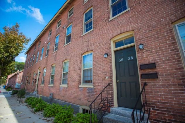 NEW ERA: This eight-unit building includes apartments that originally housed workers at the mill. The exterior was refreshed with a cleaning and repointing of masonry. / COURTESY GRETCHEN ERTL PHOTOGRAPHY