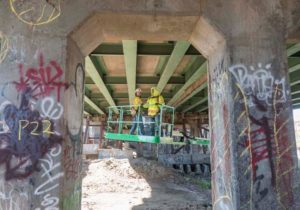 SIGNS OF WEAR: Commonwealth Engineering Inspector Niverio Carvalho, left, and Fernando Faria, engineering technician, inspect the 6-10 connector in Providence. / PBN PHOTO/MICHAEL SALERNO