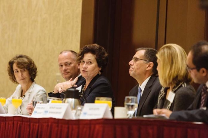 TOUGH TALK: From left, Kim Keck, president and CEO, Blue Cross & Blue Shield of R.I.; Peter Marino, president and CEO, Neighborhood Health Plan of R.I.; Sandra Coletta, Care New England, chief operating officer; Dr. Peter Hollmann, chief medical officer, University Medicine; Wendy Kagan, senior vice president, BankNewport; and Alok Gupta, R.I. Quality Institute COO, discuss medical costs at the PBN Health Care Reform Summit. / PBN PHOTO/RUPERT WHITELEY