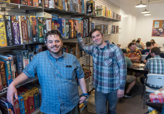 PLAYING GAMES: Rumpus Entertainment, a nonprofit catering to board game players, is located on Broadway in Providence. Their business card identifies them as "The Boardroom". From left, co-owners Phill Trotter and Tom Nimmo. / PBN PHOTO/MICHAEL SALERNO