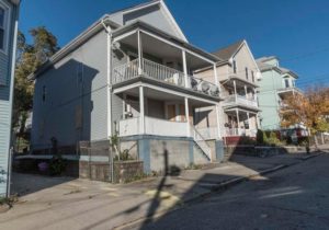ON THE BLOCK: The neighborhood abutting the area where Route 10 and Route 6 connect near Chapin Ave. in Providence. 183 Chapin Ave., on the left, is one of the problem properties on the block. / PBN PHOTO/MICHAEL SALERNO