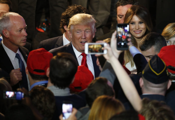 U.S. President-elect Donald Trump, center, greets attendees during an election night party at the Hilton Midtown hotel in New York on Wednesday, Nov. 9. Trump was elected the 45th president of the United States in a repudiation of the political establishment that jolted financial markets and likely will reorder the nation's priorities and fundamentally alter America's relationship with the world. / BLOOMBERG NEWS/ANDREW HARRER