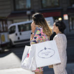A SHOPPER carries Macy's Inc. and Prada SpA bags in San Francisco. Some retail CEOs have said they are happy the presidential election is over, so consumers who were distracted by the election can focus on shopping. / BLOOMBERG NEWS/DAVID PAUL MORRIS