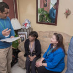 home visits: One of Neighborhood Health Plan of Rhode Island's newest initiatives includes multidisciplinary home health visits. Here Noel Hernandez, left, NHPRI community outreach specialist, and Terri Venditto, right, RN and medical case manager, visit NHPRI member Altagracia Martinez. / PBN PHOTO/MICHAEL SALERNO
