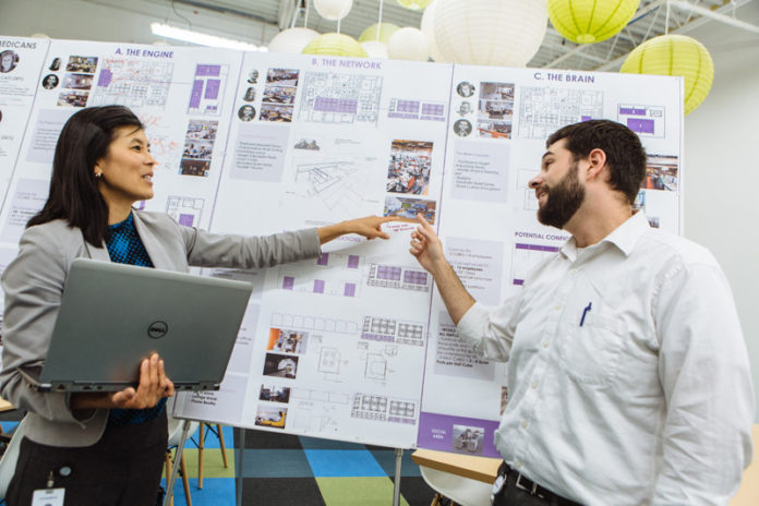 BETTER OUTCOME, LOWER COST: Michelle Wu, Ximedica vice president of quality, and Bradley Codkind, design insurance engineer, discuss a project at the company's Providence headquarters. / PBN PHOTO/RUPERT WHITELEY