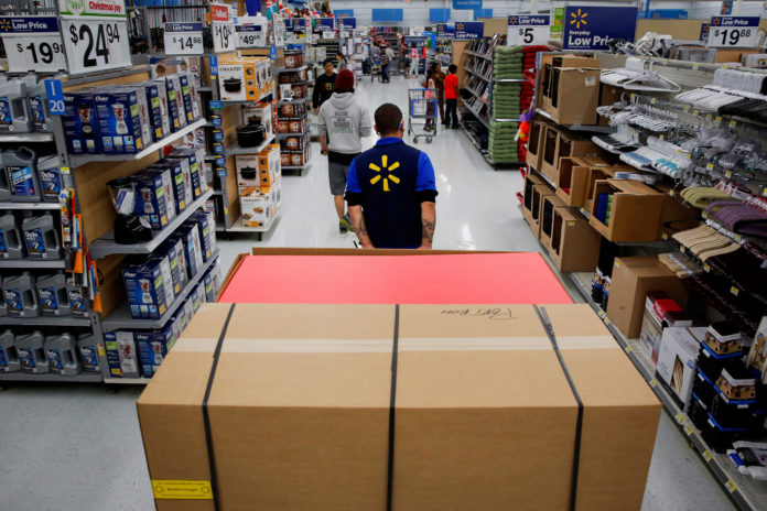 AN EMPLOYEE pulls a forklift with display units for DVD movies at a Wal-Mart Stores Inc. location ahead of Black Friday in Los Angeles in this file photograph. / BLOOMBERG NEWS FILE/PATRICK T. FALLON