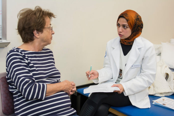 HELEN KWETKOWSKI discusses her daily medication regimen with pharmacy student Nada Elgabrouny during the Senior Health and Wellness Program held at URI last month. / COURTESY NORA LEWIS