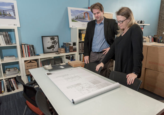 GETTING CREATIVE: Owners Rebecca McGeorge, interior design director, and Matthew McGeorge, principal architect, go over plans at McGeorge Architecture Interiors, a small business focused on interior design and construction in East Greenwich. / PBN PHOTO/MICHAEL SALERNO
