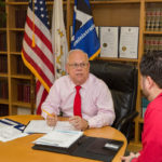 LENDING A HAND: Mark S. Hayward, left, U.S. Small Business Administration Rhode Island district director, talks with Ryan Brissette, SBA economic-development specialist. / PBN PHOTO/TRACY JENKINS
