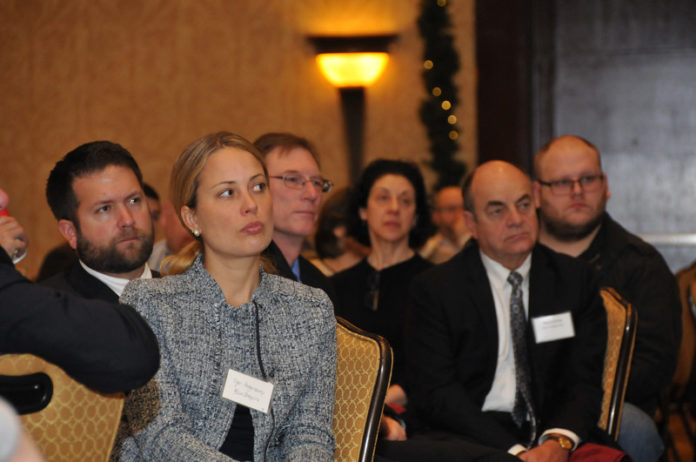 TAKING IT SERIOUSLY: Jen Hogencamp, foreground, of BlumShapiro was among the roughly 200 attendees at PBN's Dec. 8 Cybersecurity Summit, which touched on the technological and human resource challenges facing businesses in the Information Age. / PBN PHOTO/ MIKE SKORSKI