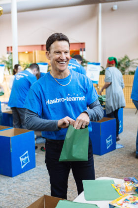 CORPORATE CITIZEN: Hasbro Chairman, President and CEO Brian Goldner helps wrap toys during the company's all-employee volunteer day. He believes there's a connection between being in the toy industry and being a good corporate citizen. / PBN PHOTO/RUPERT WHITELEY