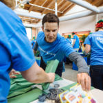 Hasbro executes on plan that includes more than toys, games JOINING IN THE FUN: Hasbro Chairman, CEO and President Brian Goldner took part on Dec. 15 in a company-wide effort at its Pawtucket headquarters to pack toys for children and families. / PBN PHOTO/ RUPERT WHITELEY
