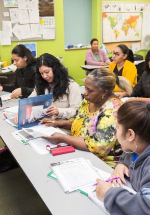 IMMIGRANT SUPPORT: Keiry Tejada, left, and Erica De La Cruz, second from left, take part in an immigrant adult education class at Dorcas International Institute of Rhode Island in Providence. / PBN PHOTO/TRACY JENKINS